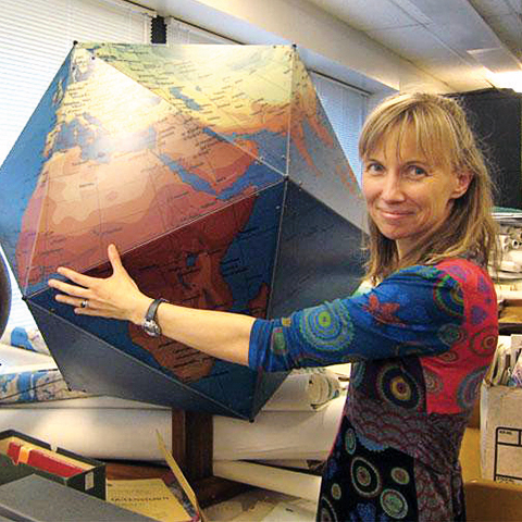 Katy Borner holding a giant world